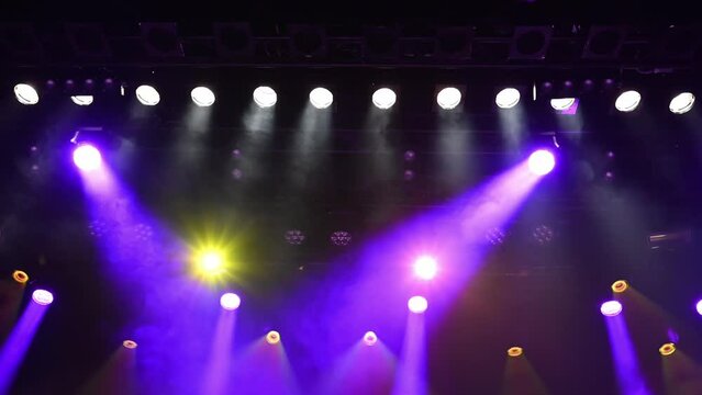 musical concert stage purple and blue lightning lights the stage, working spotlights