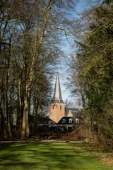 Fotobehang Reformed church or Maartenskerk from grounds of huis Doorn manor house, Netherlands on sunny day. Religious Dutch historic building place of worship in community originally known as St. Maarten © drew