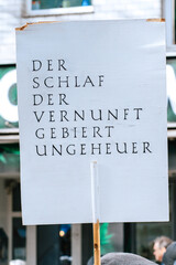 Philosophical Quote on Protest Sign, Intellectual Public Demonstration. A white sign with a German...