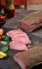 Assorted meat village homemade delicacies among vegetables and herbs