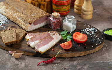 Assorted meat village homemade delicacies among vegetables and herbs