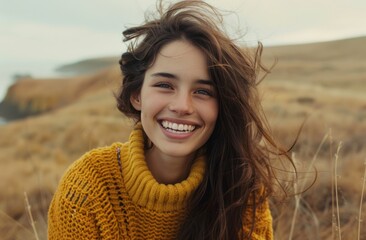 Fototapeta premium young woman dressed in yellow sweater laughing in front of camera