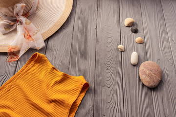 beachwear orange woman top outfit hat bag sun protection sunglasses pebbles.