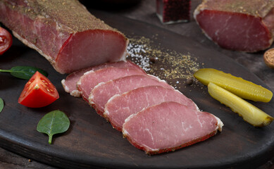 Meat dried pork ham cut into strips among vegetables and herbs