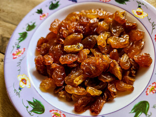 Raisins or dried grapes in a small plate