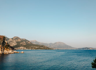 Fototapeta na wymiar Top view Montenegro Sutomore stones beach blue turquoise Adriatic sea water mountains day