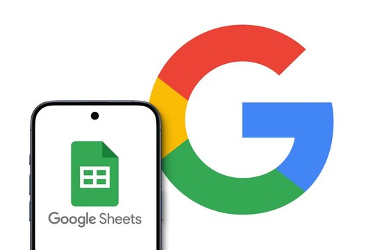 Google Sheets logo is displayed on a modern smartphone, spreadsheet application, big Google Logo in the background, create and edit documents, Collaboration