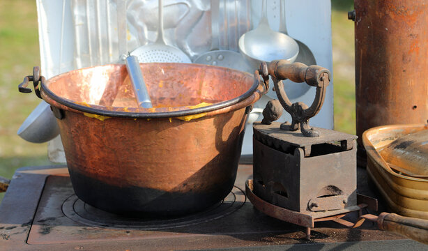 large copper cauldron and a very old heavy cast iron over the wood stove
