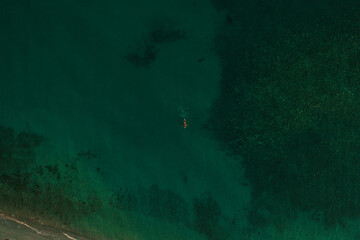 Fototapeta na wymiar Aerial top nature view above green turquoise Thracian sea Greece Ellada. Beautiful woman bikini
