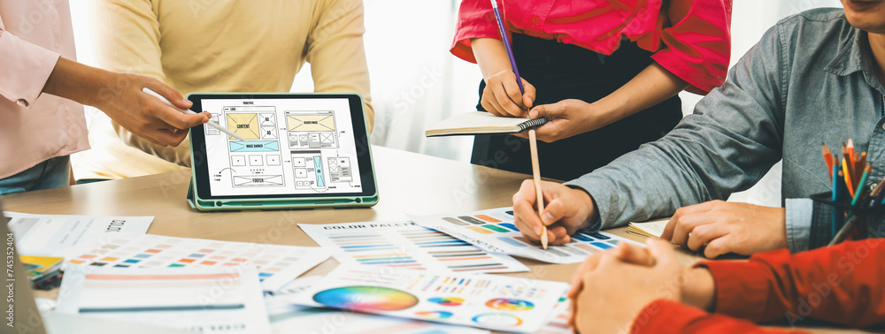 Poster cropped image of interior designer team discuss the material color while tablet displayed website wi