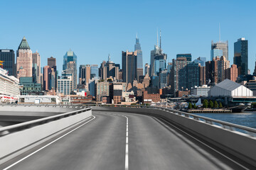 Fototapeta na wymiar Empty urban asphalt road exterior with city buildings background. New modern highway concrete construction. Concept of way to success. Transportation logistic industry fast delivery. New York. USA.