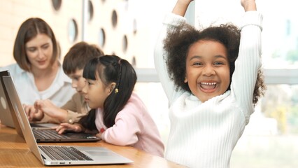 African girl play laptop with diverse friend learning prompt at STEM technology class....