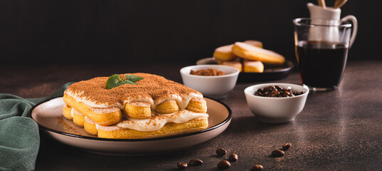 Tiramisu classic dessert with cookies, mascarpone and coffee on a plate web banner