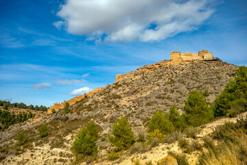 Fototapeta na wymiar View of the ruins of the medieval castle of Pliego, Murcia Region, Spain, on a steep, rocky hill