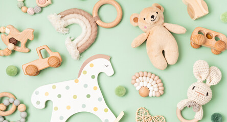A playful collection of sustainable baby toys including wooden vehicles, knitted animals, and a...
