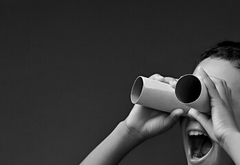 boy looking through binoculars toilet paper roll with people stock image stock photo	