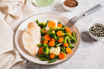 Boiled assorted vegetables and chicken fillet for diet food on a plate