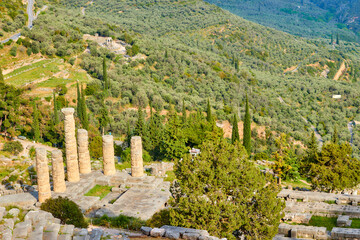  Apollo Temple or Apollonion and its doric pillars in sunset. Tourist spot, famous for oracle at the sanctuary dedicated to Apollo. Mount Parnassus, Delphi.