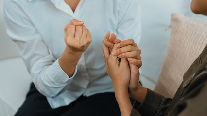 Supportive and comforting hands cheering up depressed patient person or stressed mind with empathy. Psychologist reassuring stressful and sad patient in vivancy clinic.