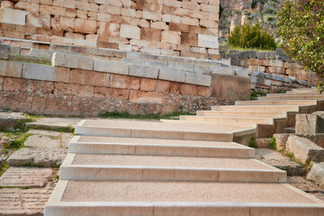 Stone stairs at Apollo Temple and theater, illuminated by sunset. No one, UNESCO site, Delphi, Greece.