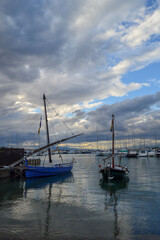 Two old Latin fishing boats with a cloudy sky
