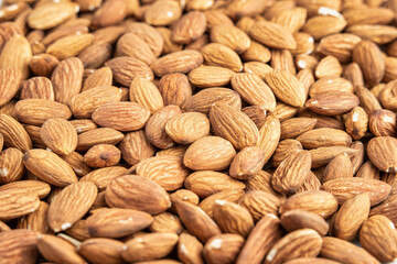 Close up with many fresh organic peeled almonds . Natural texture background.