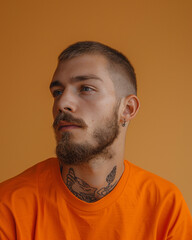 Portrait of a man in an orange T-shirt, orange background