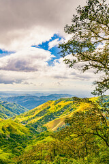 Obraz premium Verdant slopes of Monteverde under a dynamic sky, showcasing the rich biodiversity and layered mountain vistas of Puntarenas Province, Costa Rica. High quality photo.