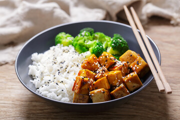 plate of rice, fried tofu, broccoli with sesame seeds