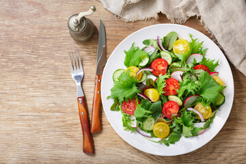 plate of salad with fresh vegetables, top view