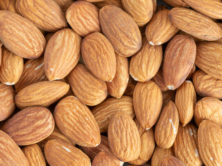 Close up with many fresh organic peeled almonds . Natural texture background.