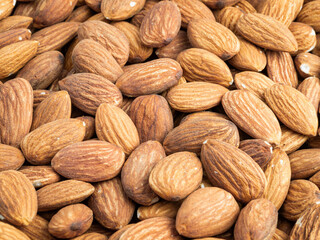 Close up with many fresh organic peeled almonds . Natural texture background.
