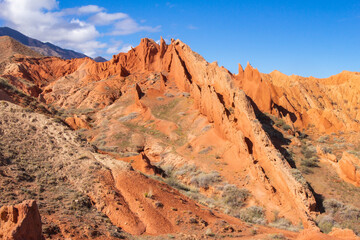 landscape of Skazka canyon on Issyk-Kul lake. Rocks Fairy Tale famous destination in Kyrgyzstan. Mountain like great wall of china and Rainbow Mountains of Danxia or Antelope crevice USA. Central Asia