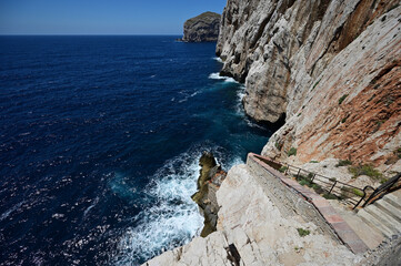 A stairway called Escala del Cabirol, cut into the cliff, leads from the top of the cliff at Capo Caccia down to the entrance to Neptune's Grotto