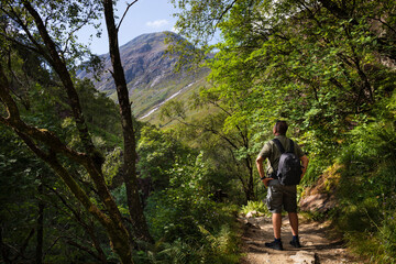 A person views Ben Nevis mountain from the walking route heading to Steall Watefall in the Scottish...