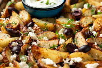 Greek fried potatoes with feta cheese, kalamata olives, parsley and dill