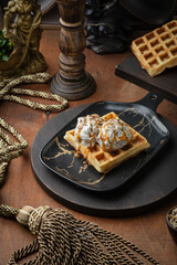 Viennese waffles with ice cream and caramel in vintage royal style