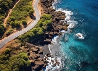 Aerial view of road next to ocean.