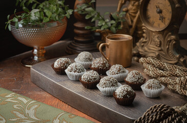 Chocolate candies with sesame and coconut topping. Vintage style