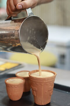 A man is pouring traditional Indian clay pot tea. He is also known as conventional Kulhad tea.