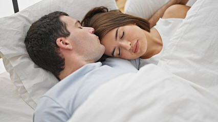 Beautiful couple lying on bed kissing on head sleeping at bedroom