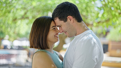 Fototapeta premium Beautiful couple smiling confident standing together looking each other at park