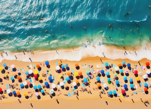 Aerial view of crowded beach with umbrellas.