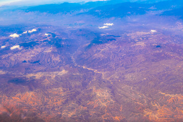 Flying airplane over Mexico Clouds Sky Volcanoes Mountains City desert.