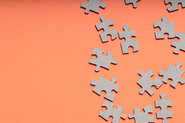 Pieces of Jigsaw Puzzle on Orange Background, Teamwork Abstract Concept