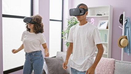 Fototapeta premium Gaming glow, beautiful couple's love blooming in virtual reality dance video game while enjoying music, using futuristic gadget glasses at home
