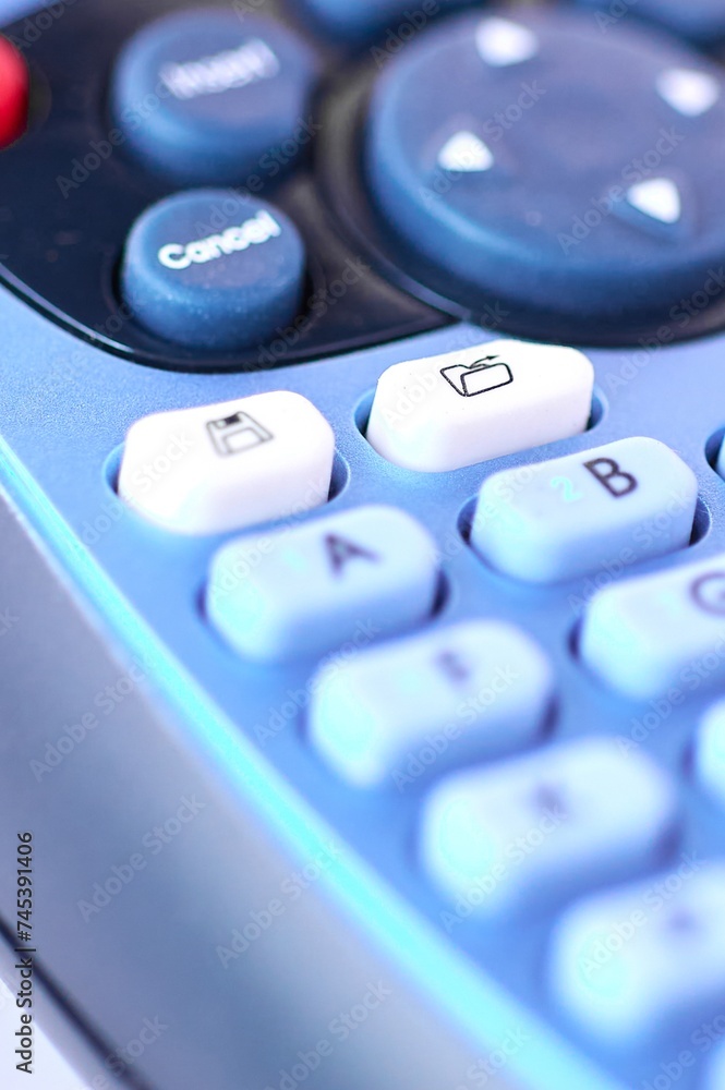 Poster detailed image of a blue electronic labeling machine for thermal printing ribbon, focusing on the fi