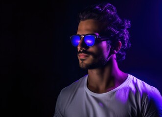 Man With Glasses Standing in Front of Purple Light