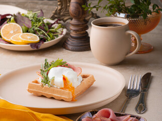 A poached egg cut into a Viennese waffle. Holiday breakfast in vintage style