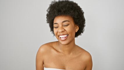 Portrait of a joyful african american woman with curly hair against an isolated white background,...